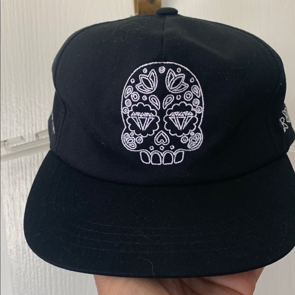 Black Cap with White Skull Embroidery with Modelo embroidered on side. Unisex